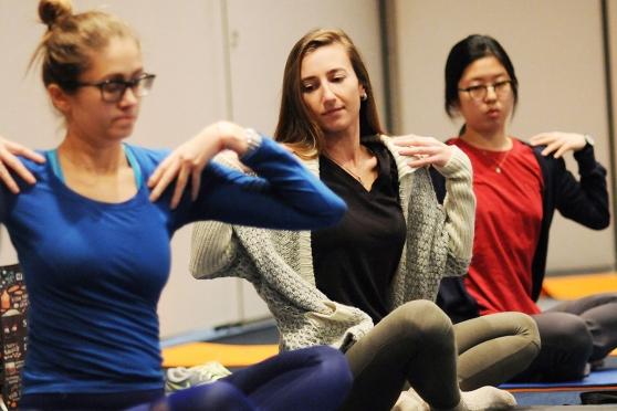 Speech teacher Khrystyna Vrublevska (center) takes yoga with fellow members from