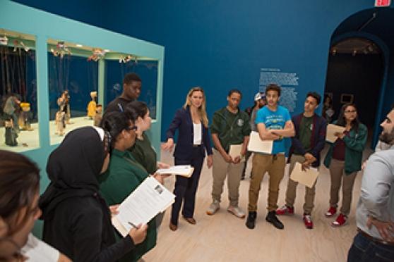 Students discuss the unusual marionettes, which are also featured in the artist’s video on the ancient roots of modern conflicts.