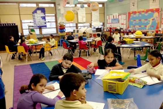 First-graders are happily at work at their colorful new tables. 
