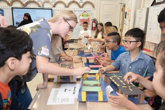 Classroom teacher Allison Scarpa admires her 3rd-graders’ work.