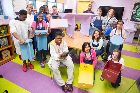 Students at PS 721 in Gravesend show off furniture they are making for their new