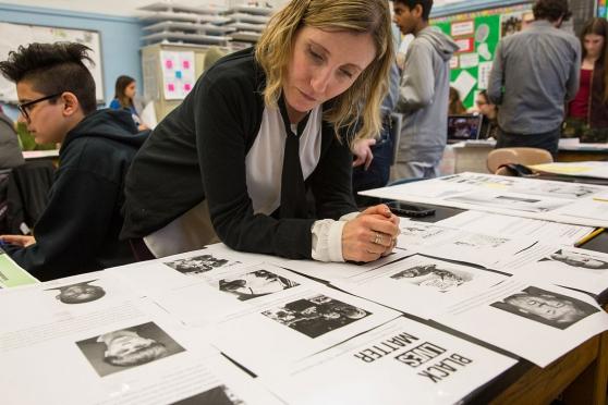 School counselor Star Corvinetti looks at students’ work.