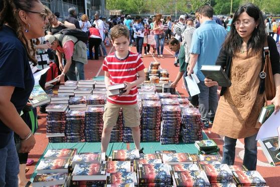 Kids browse through the stacks of books in the schoolyard at Abraham Lincoln HS 