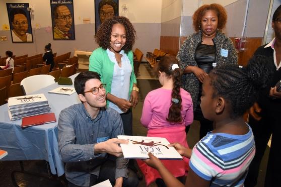 Author-illustrator Brendan Wenzel gives autographed copies of his book — “They A