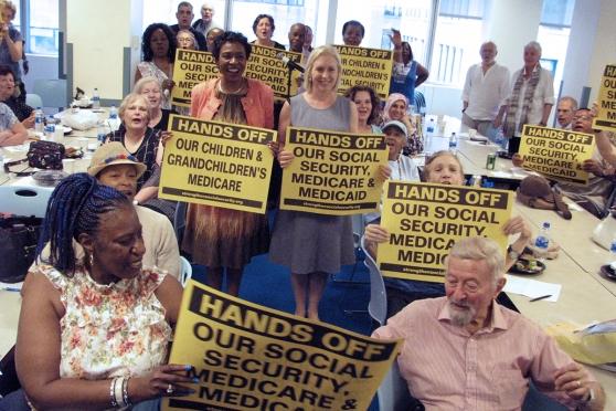 Retirees hlding signs, "Hands off our social security"