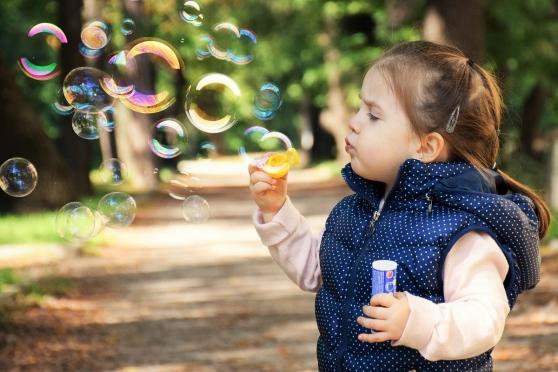 Preschooler blowing bubbles - generic
