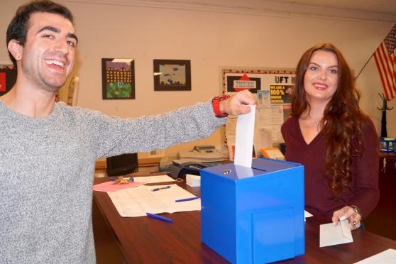 Members stuffing ballot in box
