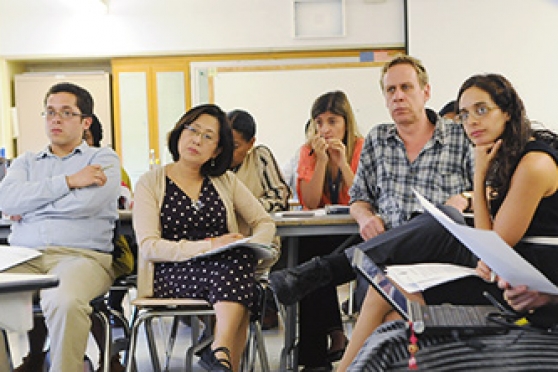 The staff observe the demonstration.