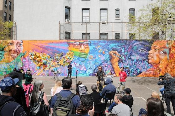 The founders of Artolution speak as the mural is presented.