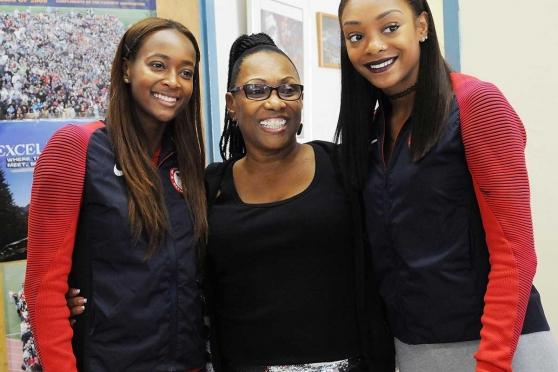 It’s a happy reunion for (from left) Dalilah Muhammad, DeVore and Stevens.