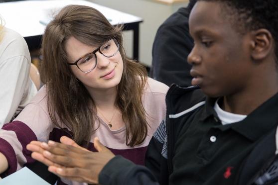 English teacher Katherine Clark (center) helps prepare a student for the difficu