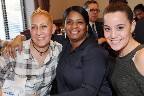 Honoree Esther Maldonado-Smith (left) is congratulated by PS 373 colleagues Pame