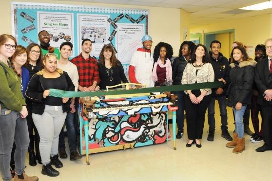 Students and staff welcome the Sing for Hope piano to its new home at Pathways t