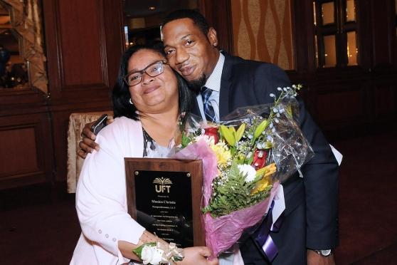 Christie receives flowers from Anthony Barnes of the UFT certification departmen