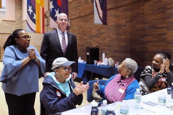 NYPD Commissioner James O’Neill and Pryor-Holland (standing) visit the hand-stit