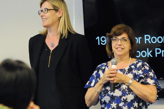 Speech Teacher Chapter Leader Mindy Karten Bornemann (right) is passing the bato