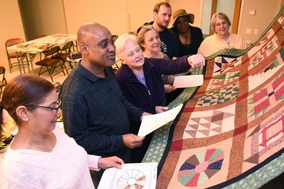 Retiree Stephanie Kollar, a former art teacher, (third from left) explains how e