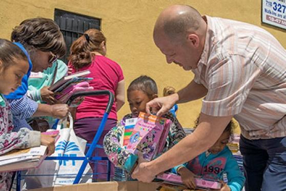 UFT President Michael Mulgrew helps children make their selections.