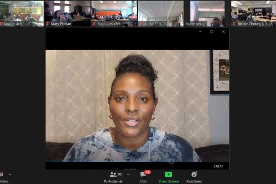 A zoom call with a woman centered in the screen