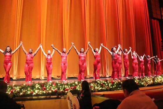 Students perform with the Rockettes on stage