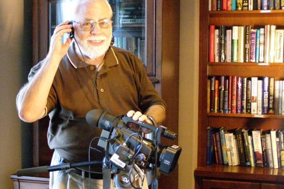 Michael Rothfeld tests his audio feed for his video camera.