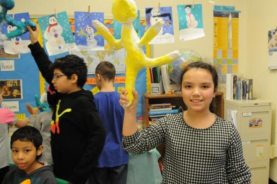 Students show off their puppets