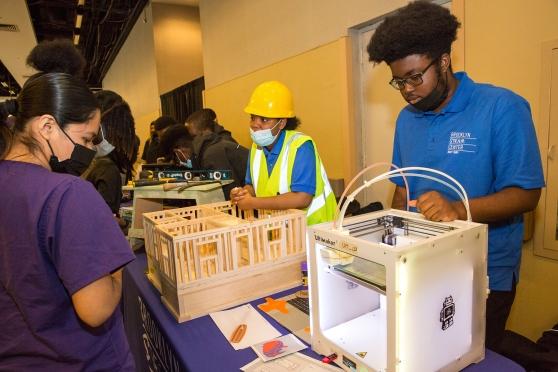 Brooklyn Steam Center Navy Yard students show off a 3D printer and a model they made.