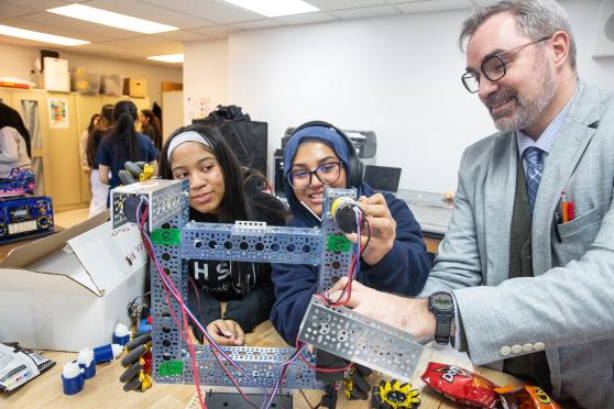 Computer science teacher Andy Jordan leads students in his robotics intensive at ember, the  usual bell schedule at The Young Women’s Leadership School of Astoria.