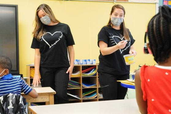 Occupational therapists Kaitlyn McEvoy (left) and Farah Hotchkiss work with students in the class