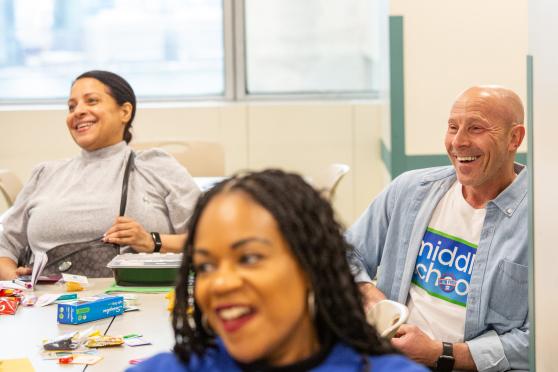 UFT Vice President for Middle Schools Richard Mantell shares a laugh alongside paraprofessional Sharlene Corcino (left) of JHS 194 in Queens and school counselor Roy of MS 581 during a workshop on boosting student morale.