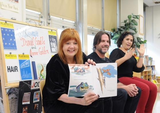 Actor Annie Golden (left) reads a book written by playwright David Caudle (middl