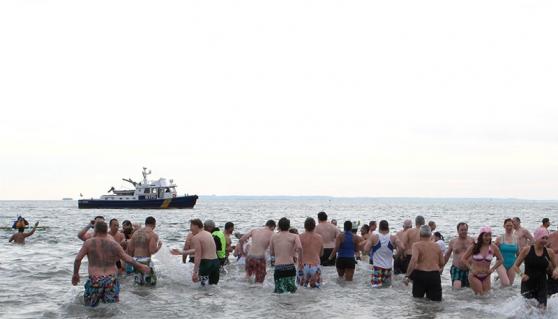 Adventurous New Yorkers frolic in the ocean off Coney Island.