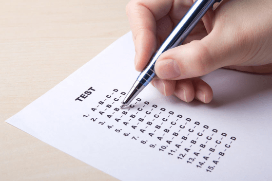 Person filling out a bubble test 