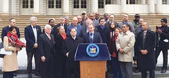 New York State Attorney General Eric Schneiderman, surrounded by labor leaders a