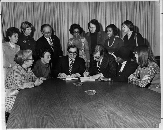 UFT President Albert Shanker (seated, third from left) and Joseph Monserrat, the