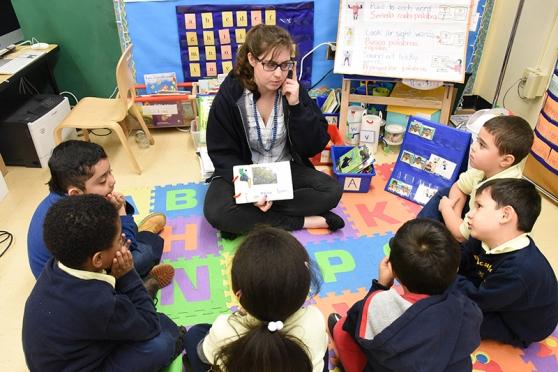 Kindergarten teacher Caitlyn Duffy reads a book with her students that they co-wrote as a group.