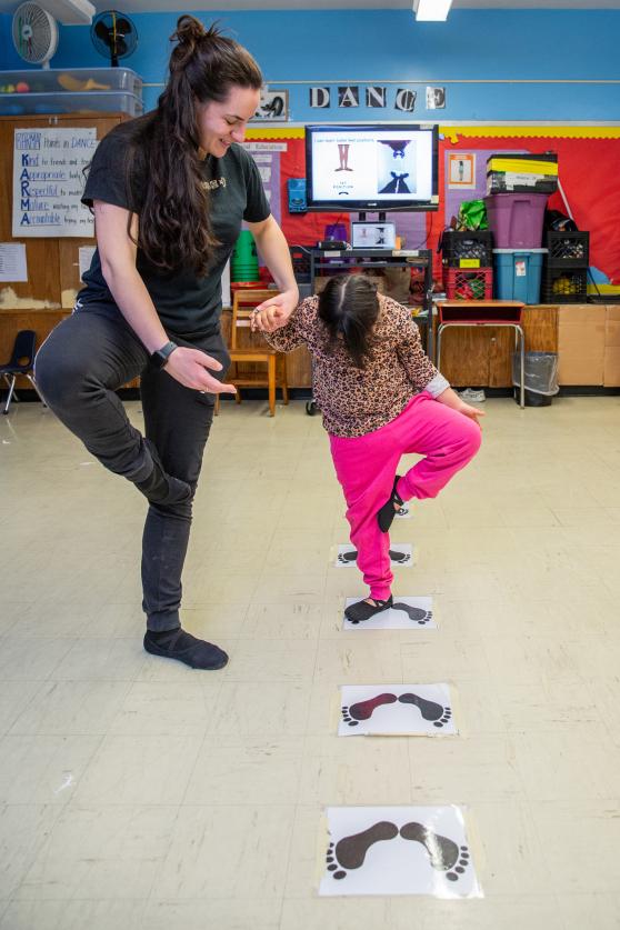 Special education teacher Megan Moellendorf works with a student using 'foot maps' that she created to help her students learn ballet positions. 