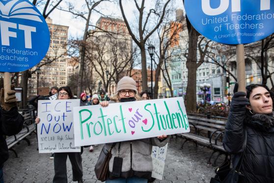 Julie Cohen, a teacher at Urban Assembly Maker Academy HS in lower Manhattan, carries a homemade “Protect Our Students” sign and marches with other UFT members.