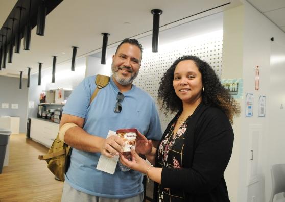 A woman and man take a photo after the man receives ice cream for donating blood.
