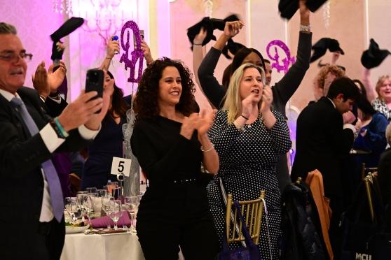 Attendees cheer on an award winner at the District 11 Scholarship Dinner Dance