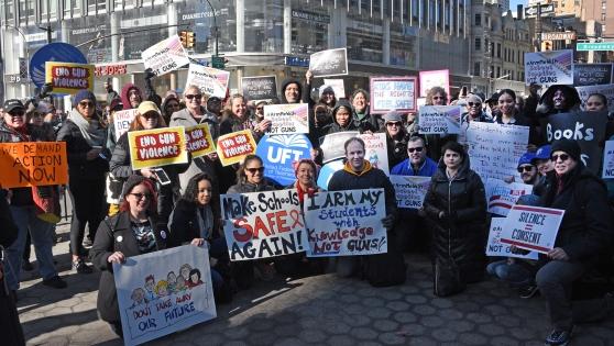 UFT members hold up their signs at the March for our Lives in Manhattan