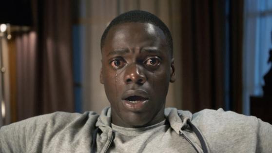 A scene from the movie "Get Out" when the main character is crying in the middle of the screen.