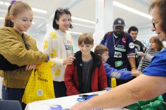 Parents and their children check out an informational table at the Staten Island Family Partnership Summit on Nov. 9 at the UFT Staten Island borough office.