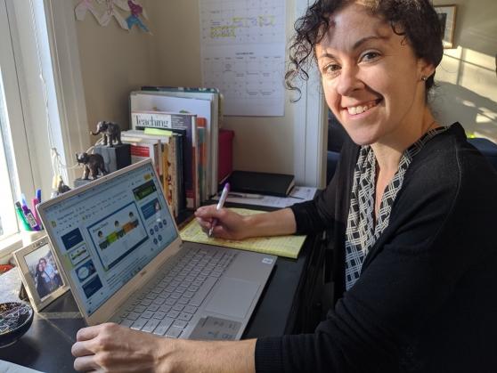 Lisa Berke poses in front of a compter screen