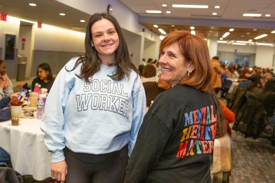 Two social workers in attendance at 2025 Clinicians Appreciation Day smile while taking a photo. 