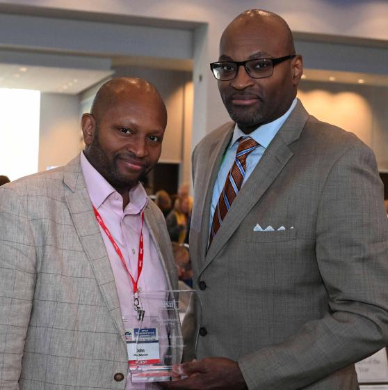 Former UFT Vice President for Career and Technical Education Sterling Roberson (right) received the Retiree of the Year Award during the May 1–2 convening of the Representative Assembly of NYSUT, the UFT’s state affiliate. 