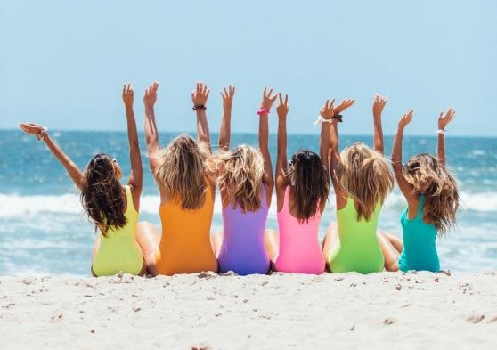 friends-on-beach-bright-swimsuits
