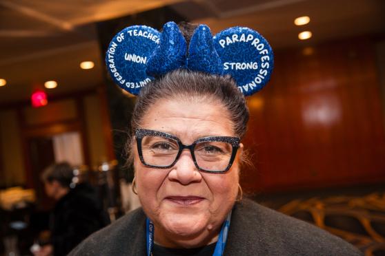 A paraprofessional in attendance at the UFT Paraprofessionals Awards Luncheon shows off her Mickey Mouse ears that she wears in class to amuse her students. 