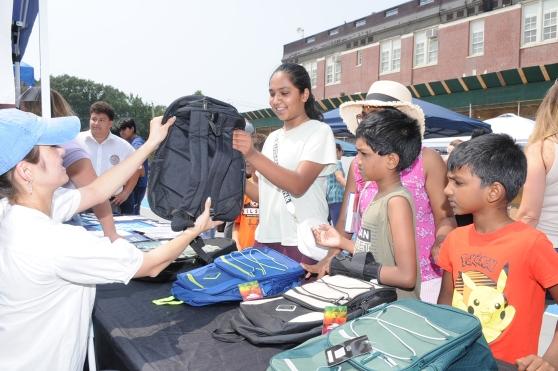 Children select new backpacks at the union's fourth annual back-to-school supplies giveaway and barbecue on Staten Island. 