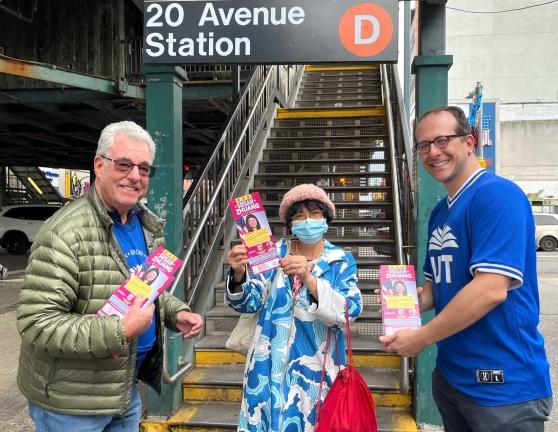 Three UFT members showing campaign literature